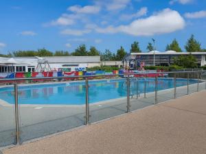 a swimming pool with a metal fence around it at Lakeland Leisure Park - Holiday Accommodation 20349 in Flookburgh