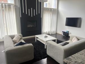 Una sala de estar con dos sillas y una mesa. en Evanston House, en Calgary