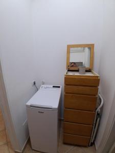 a laundry room with a washer and a dresser at Casa Roberto Beach in Torvaianica +25 photos