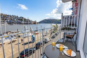 a balcony with a table and a view of a marina at Harbourside 2 in Dartmouth +7 photos