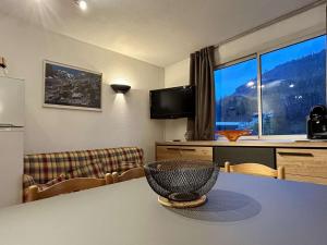 a room with a table with a bowl on it at Appartement cosy 2 pièces, proche télécabine Prorel et centre de Briançon, parking inclus - FR-1-330C-44 in Briançon