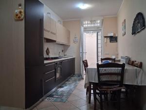 a kitchen with a table and a dining room at Casa Roberto Beach in Torvaianica