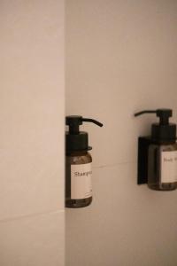 a bottle of shampoos hanging on a wall at Mas Les Arrabassades in Castelló d'Empúries