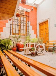 a bench sitting in front of a building with plants at Villa Sillar in Arequipa