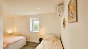 ein kleines Schlafzimmer mit einem Bett und einem Fenster in der Unterkunft La maison bleue in Brive-la-Gaillarde