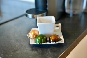 a plate of chocolates on a counter with a cup at Ferienwohnung Paula in Sankt Georgen im Schwarzwald