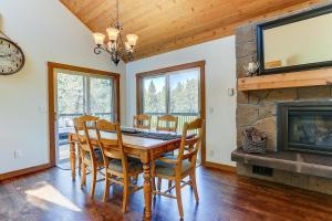 a dining room with a table and chairs and a fireplace at 3 Spyglass in Sunriver