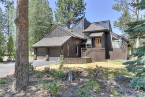 a wooden house with a tree in front of it at 3 Spyglass in Sunriver