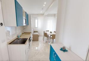 a kitchen with a sink and a table in a room at Residence Flow-R in Riccione