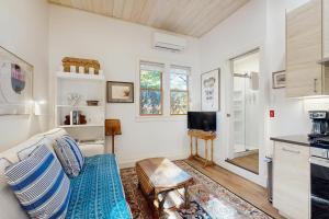 a living room with a couch and a tv at Walker Cottage in Rockport
