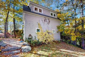 a house in the woods with trees at Walker Cottage in Rockport