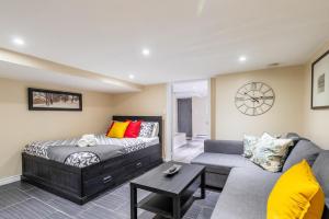 a living room with a bed and a couch at Modern Suite Condo Heart Of St Clair West - Bloor Hotel in Toronto