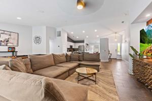 a living room with a couch and a table at Navigate Stays Luxe Retreat w Pool Spa & Games in Desert Groves Mobile Home Park