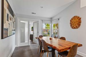 a dining room with a wooden table and chairs at Navigate Stays Luxe Retreat w Pool Spa & Games in Desert Groves Mobile Home Park