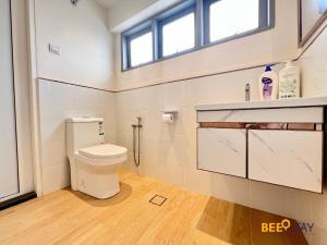 a bathroom with a toilet and a window at SS2 Landed in Petaling Jaya for 8 Pax in Gua Sai +32 photos