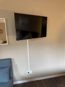 a flat screen tv hanging on a wall at Apartments KR in Cologne