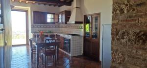 een keuken met een aanrecht en een tafel met stoelen bij Agriturismo La Rugiada di Pociano in Monteroni dʼArbia +54 foto's