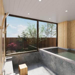 a bathroom with a large window and a swimming pool at KITAMAE BASE Kaga Hashitate in Kaga