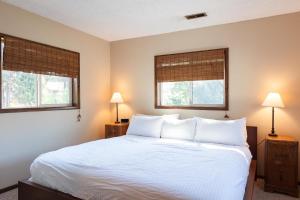 フッド・リバーにあるHeartbreak 30 day minimumのベッドルーム1室(白いベッド1台、窓2つ付)