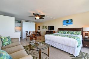 a bedroom with a bed and a living room at Valley Isle 407 · VI 407 BeachFront Studio w Pool in Kahana