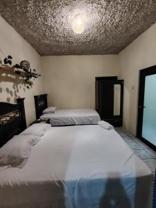 Ένα ή περισσότερα κρεβάτια σε δωμάτιο στο Casa El Recuerdo +12 φωτογραφίες