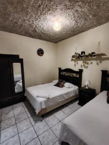 Ένα ή περισσότερα κρεβάτια σε δωμάτιο στο Casa El Recuerdo