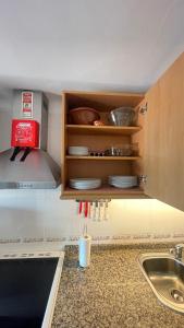 a kitchen with a counter with a sink and some dishes at CASA da LINHA in Caminha