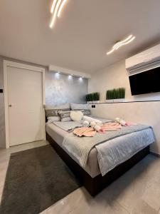 a bedroom with a large bed in a room at Apartment Sova or Deluxe room 33 in Bled