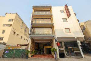 an apartment building with a balcony in front of it at HOTEL THE KIARA WITH - Free Airport Pickup Delhi Airport in New Delhi