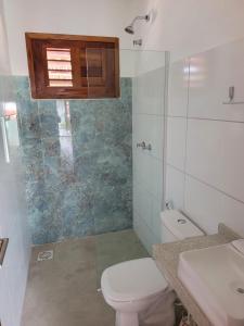 a bathroom with a toilet and a sink and a shower at Pousada Janela dos Ventos in Caucaia