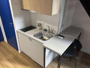 a small kitchen with a sink and a table at Heart of Kaunas - Cozy Loft with Wi-Fi in Kaunas