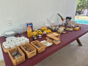 a table with a bunch of food on it at Pousada Janela dos Ventos in Caucaia
