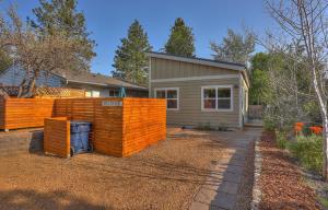 a home with an orange fence in front of a house at Mod Pod in Bend