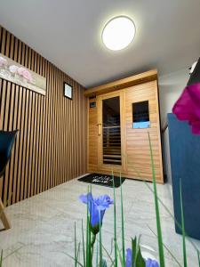 a room with purple flowers in the middle of a room at Apartment Sova or Deluxe room 33 in Bled