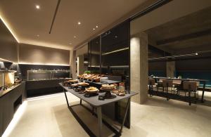 a kitchen with a buffet of food on a table at 7BA Hotel Milano in Milan