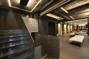 a lobby with a staircase and a bench in a building at 7BA Hotel Milano in Milan +26 photos