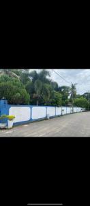 a long blue and white wall next to a street at accomodation katunayaka in Negombo