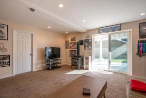 a living room with a tv and a door at Northern Daylights in White Salmon