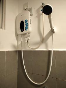 a soap dispenser on a wall in a bathroom at KLIA Airport Xiamen Sepang WiFi Gym Pool 吉隆坡国际机场 厦门大学 in Kampong Bekoh