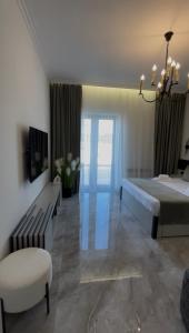 a large bedroom with a bed and a chair at DiAngelo Guesthouse in Yerevan