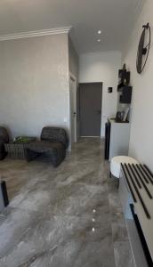a living room with a couch and a table at DiAngelo Guesthouse in Yerevan