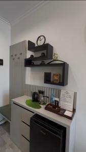 a kitchen with a white counter with a black shelf at DiAngelo Guesthouse in Yerevan