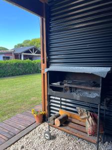 a building with a grill in a yard at Hospedaje a 2 cuadras del mar Mar de Cobo 4 personas in Mar de Cobo