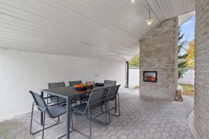 a dining room with a table and chairs and a fireplace at Black Dragon Haven Luxury Villa with Pool, Sauna & Jacuzzi in Prague