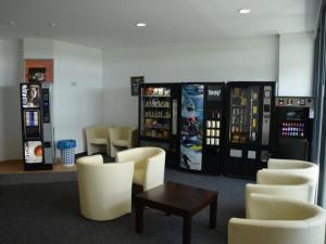a waiting room with chairs and vending machines at C & N Hostel München in Munich