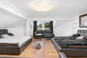a living room with two beds and a couch at Black Dragon Haven Luxury Villa with Pool, Sauna & Jacuzzi in Prague +143 photos