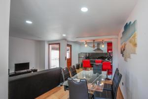 a dining room and kitchen with a glass table and chairs at Mirando Espanha in Melgaço +6 photos