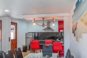 a dining room with a table and red chairs at Mirando Espanha in Melgaço