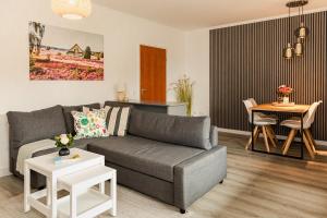 a living room with a couch and a table at HeideHygge 2 in Schneverdingen