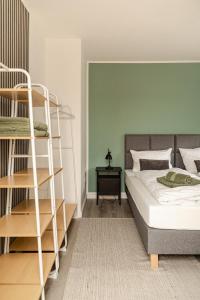 a bedroom with a bunk bed and a ladder at HeideHygge 2 in Schneverdingen